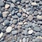 Closeup gray pebbles scattered on a peaceful beach