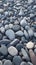 Closeup gray pebbles scattered on a peaceful beach