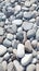 Closeup gray pebbles scattered on a peaceful beach