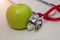 Closeup of green apple and a stethoscope healthy food and concept for diet, Healthcare, Nutrition or medical insurance. Fruit,