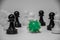 Closeup of a green coronavirus in the middle of chess troops