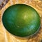 Closeup of a green metal dish, fair trade products in India