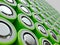 Closeup of green pile of li-ion batteries. Close up colorful rows of selection of 18650 batteries energy abstract background