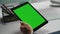 Closeup green screen tablet in hands. Office manager holding mockup device