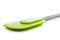 Closeup of green silicone kitchen accessory, spatula, lying on w