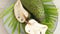 Closeup of green soursop graviola, exotic, tropical fruit Guanabana on plate