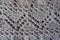Closeup of grey handmade knitted fabric with zigzag pattern