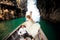 closeup groom blonde bride in fluffy sit on longtail boat nose