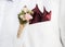 Closeup of groom boutonniÃ¨re on suit lapel