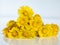 Closeup of group of bright yellow coltsfoot Tussilago farfara on white, isolated background in sunlight