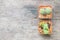 Closeup group of cactus in plastic white and brown pot on wood desk textured background in top view with copy space