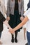 Closeup of group of females standing in circle holding hands during support group meeting