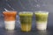 Closeup a group of iced tea drinks thai milk tea matcha latte and yuzu green tea served in plastic glass isolated dark background