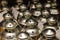 Closeup on group or lot of shining metal candle holders