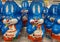 Closeup of group many blue kinder chocolate easter bunnies in shelf of german supermarket