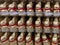 Closeup of group many lindt chocolate easter bunnies stapled in a row in shelf of german supermarket