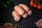 closeup group of thick short sausages with dill and tomatoes