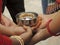 Closeup of a group of women holding a turmeric bowl at a Bengali Hindu wedding