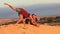 Closeup Guy Does Somersault on White Sand Dune