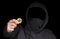 Closeup hacker hold bitcoin in hand initiating cyber attack, concept cyber security,  on black