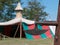 Closeup of Halberd, Medieval Pole Weapon and Tent in background