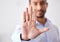 Closeup of the hand of a business man showing stop, saying no or not accepting a deal in an office at work. Male