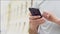 Closeup of the hand of a caucasian young male with a phone. A man types a message