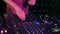 Closeup of hand of DJ on mixer and turntables. Scene. DJ equipment in night club. Concept of club music