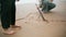 Closeup hand draw beach sand on family weekend. Unknown boy legs walking seaside