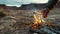 A closeup of a hand expertly starting a campfire using only natural materials. The rugged landscape in the background