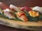 Closeup of hand-formed sushi on a wooden plate