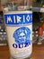 Closeup of hand holding bottle with greek Ouzo Mirios in front of shelf in german supermarket