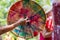 Closeup of hand holding a colourful drum