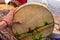 Closeup of hand holding a colourful drum