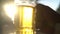 Closeup hand holding lager beer mug with sun rays