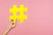 Closeup of hand holding large yellow paper hashtag symbol next to copy space, hash sign of famous media content