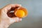 Closeup of a hand holding the shell of a broken egg yolk with a