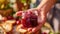 A closeup of a hand holding a small jar of homemade jam ready to be spread on freshly baked bread