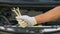 Closeup of hand holding spanners, repairing car in garage, upgrading vehicle