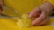 Closeup of hand with knife cutting fresh vegetable. Woman cutting potatoes on a white cutting board closeup.