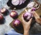 Closeup of hand peeling red onion