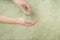 Closeup hand of a person holding bottle of cologne