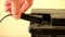 Closeup hand unplug car battery charger black clamp accumulator