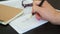 Closeup of Hand of Woman Signing Document