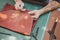 closeup hand working process leather handcraft in the leather workshop. Man holding crafting tool and working.