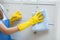 Closeup hand of young asian woman in gloves cleaning home in room, housekeeper is wipe with fabric.