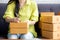 Closeup hand of young asian woman writing address on parcel box at home for delivery order to customer.