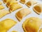 Closeup of handmade ravioli on the tray ready to be cooked.