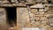 Closeup of handmade stone construction with a rectangular opening as a window