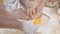 Closeup hands of African American family with daughter add egg to flour and thresh for cooking with father and mother together.